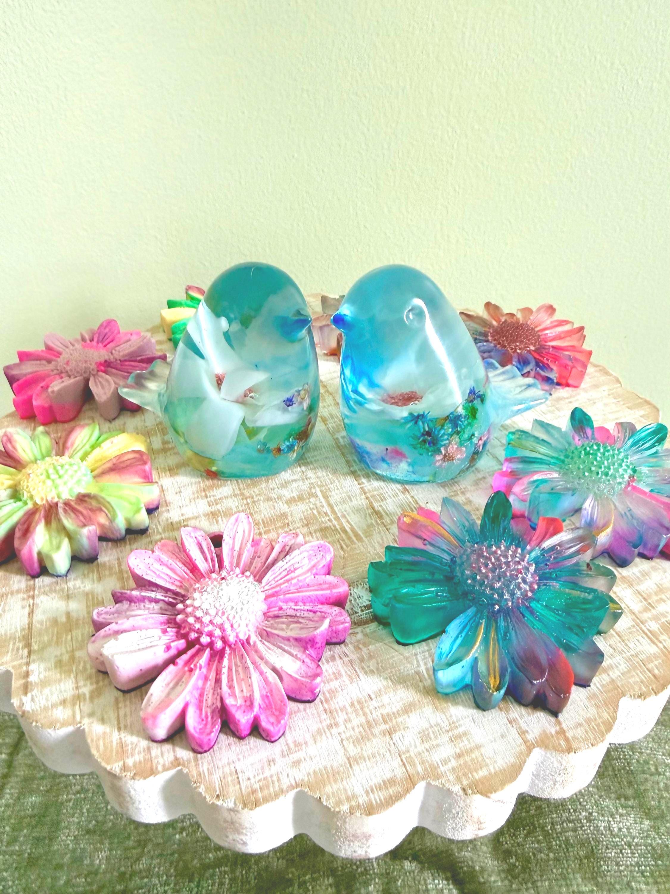 Colorful ceramic birds and flowers on a decorative plate with a light green background